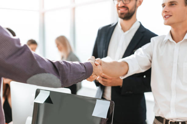 istock close up. young business people greeting each other with a handshake 1284765882