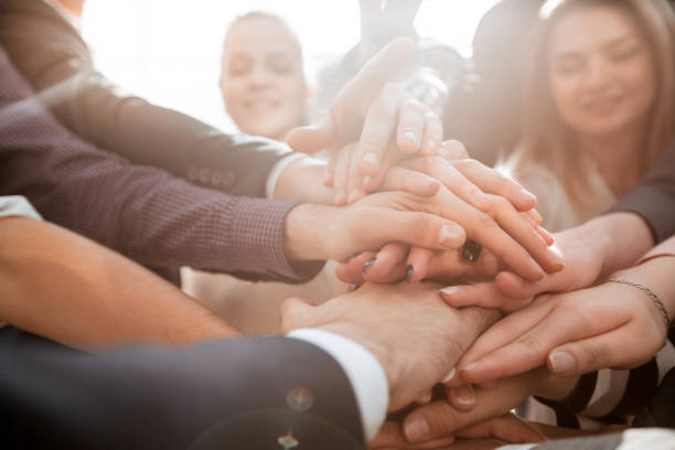 istock close up. a group of young business people showing their unity 1284765925