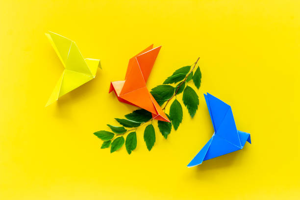 istock Colored origami - paper birds with leaves, overhead view 1284765930