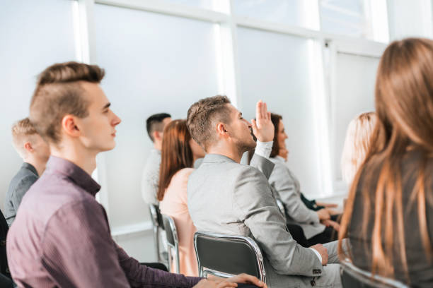 istock close up. business seminar participants ask questions 1284766534
