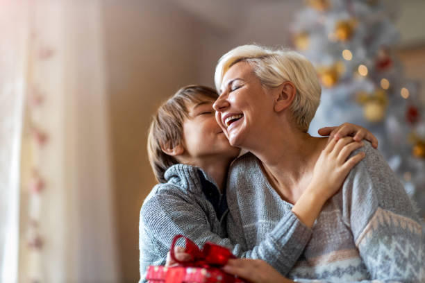 istock Happy son giving mother Christmas gift 1284766943