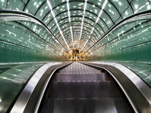 Rolling staircase, blue illuminated at a metro/underground station in Naples, Italy.