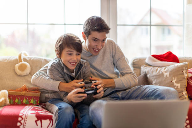 Two Brothers Playing Computer Games at Christmas Time