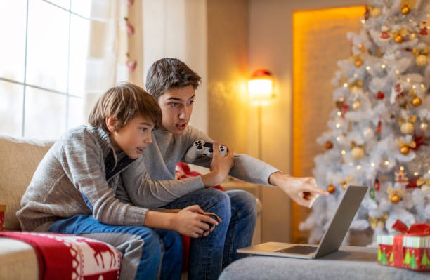 istock Two Brothers Playing Computer Games at Christmas Time 1284768104