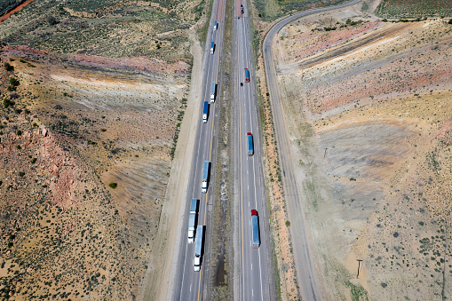 An Aerial View of a Steam Passenger Train Approaching, Traveling Thru Open Farmlands, Blowing Lots of White Smoke, on a Winter Day