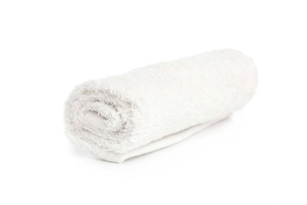 istock one white clean towel rolled up on a white background 1284770038