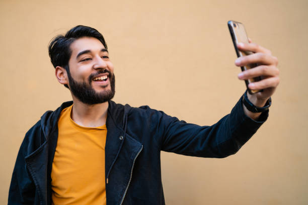 istock Young man taking selfies with phone 1284770444