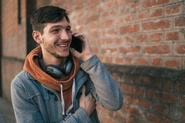 istock Young man talking on the phone outdoors. 1284770508