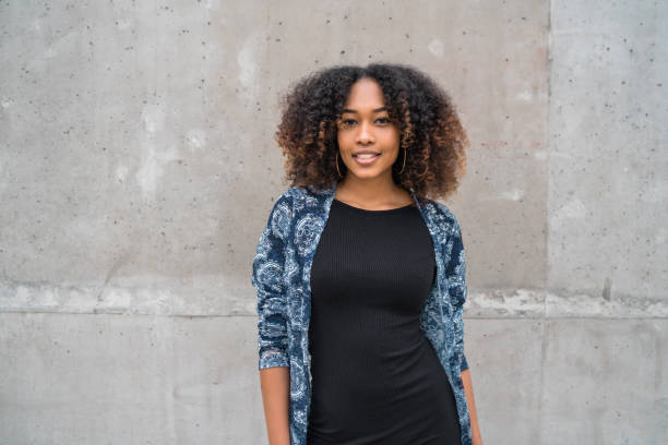 istock Afro-american woman against grey wall. 1284770652