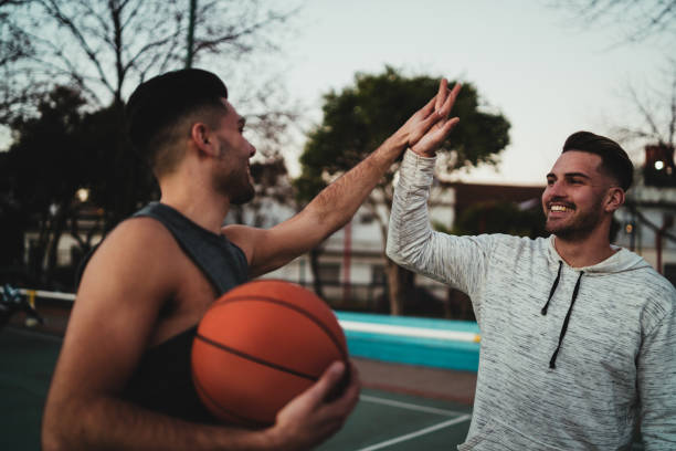 istock Two young friends playing basketball. 1284770682