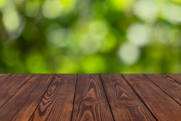 istock wooden empty table with blurred green garden 1284773537