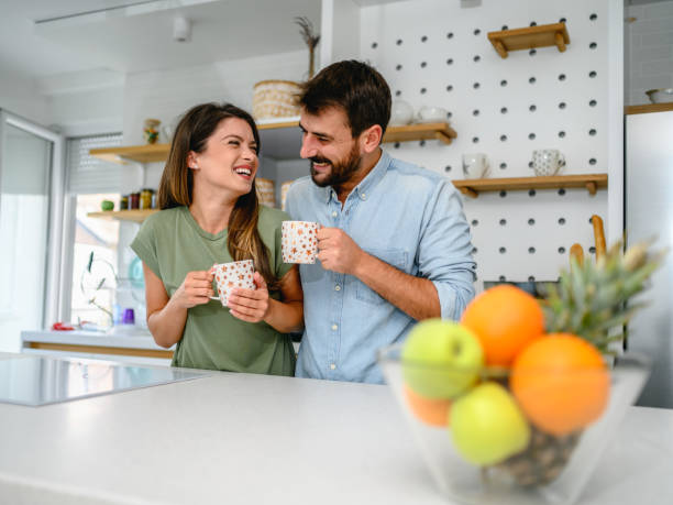 istock Couple having coffee together in the kitchen at home 1284774125