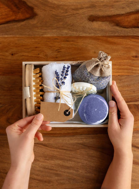 Preparing homemade gift box or self care package with bath accessories and lavender aromatherapy cosmetics. Sustainable Christmas, zero waste, plastic free.