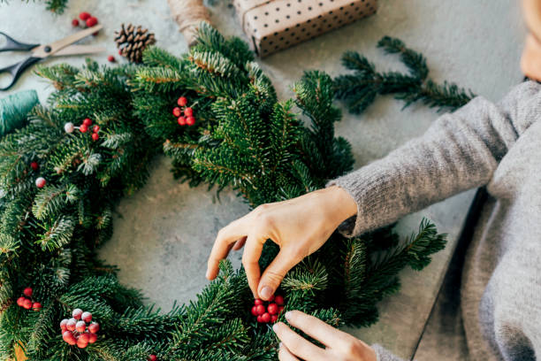 istock A woman is crafting a wreath for Christmas. 1284776187