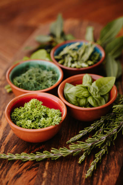 istock Four different tasty herbs on a rustic wooden board with focus on the parsley 1284777383
