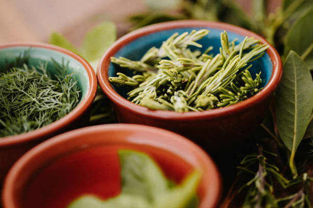istock Different tasty herbs on a rustic wooden board with focus on the rosemary 1284777416