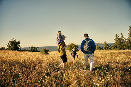 Rearview shot of a young couple out on an adventure together with their two kids