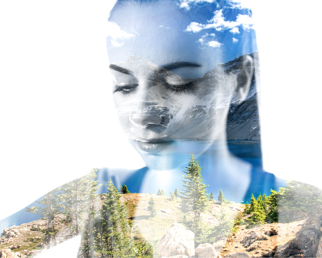 Double exposure of young woman doing yoga and mountain landscape with lake