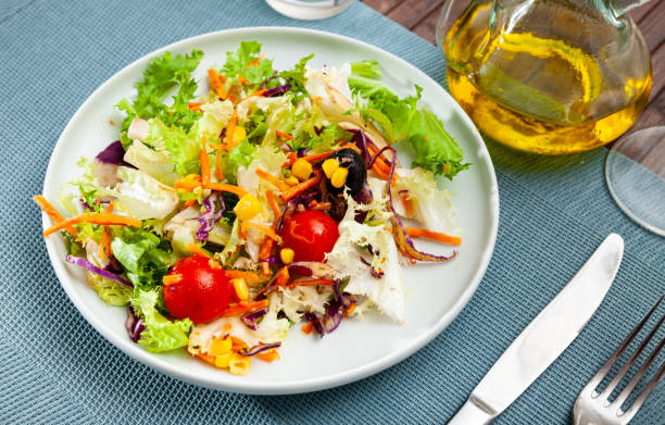 istock Salad with lettuce, tomato, corn and olives 1284778854