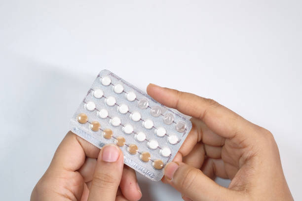 istock women hand holding birth control pills close up 1284778930