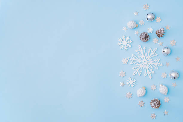 istock Flat lay border with christmas decorationon and snowflakes on a blue background 1284778986