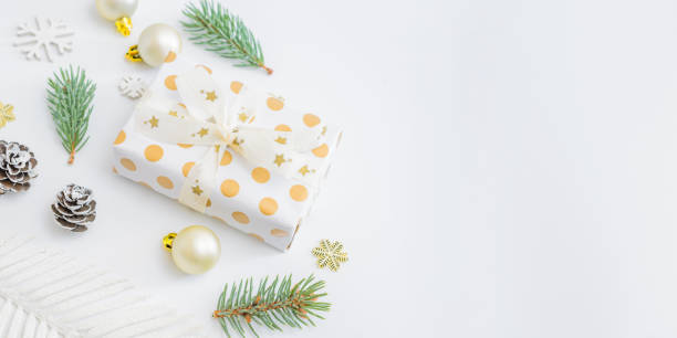 istock Frame with fir branches, christmas baubles decoration and gift box on a white background 1284778991