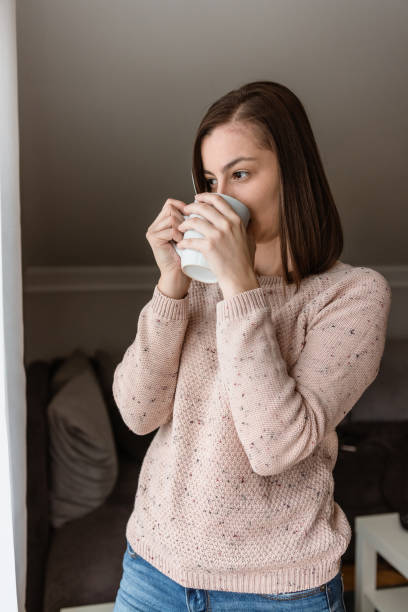 istock Young woman having a cup of coffee 1284779990