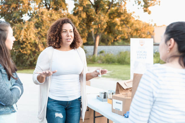 istock Female volunteers chat before getting to work organizing food 1284781136