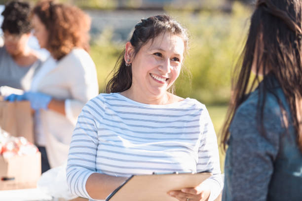 istock Cheerful food drive coordinator signs up unrecognizable volunteer 1284781145