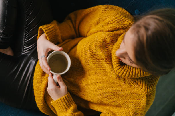istock Young woman holding cup of tea 1284781222