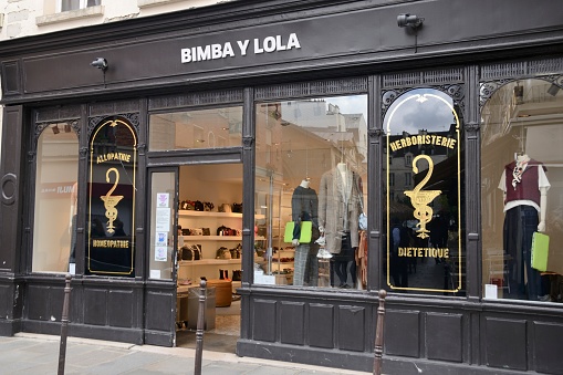 Paris, France - September 26, 2020: Fashion store in an old pharmacy in street of Paris, France.