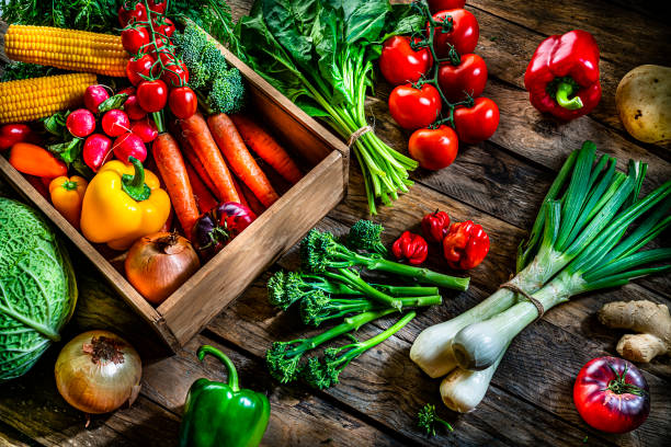 istock Healthy food backgrounds: fresh multicolored vegetables on rustic table. 1284782597