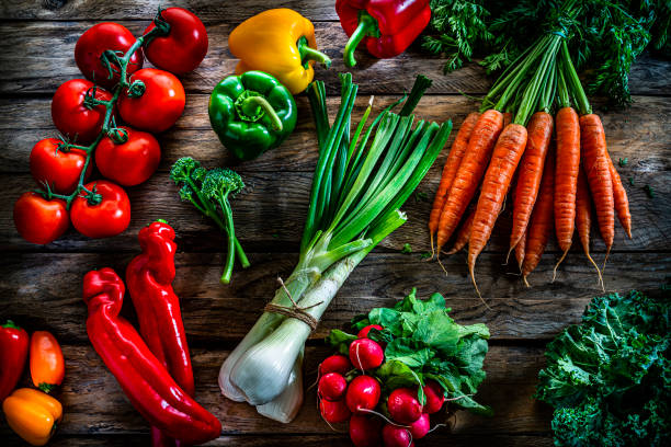 istock Fresh organic vegetables shot from above on rustic wooden table. 1284782640