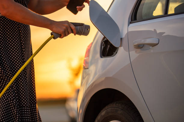 istock Hand holding electric car charger 1284782839