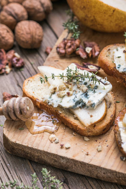 istock Toast or canape  with goat cheese, thyme, honey, nuts.  Delicious appetizer, ideal as an aperitif. 1284782888