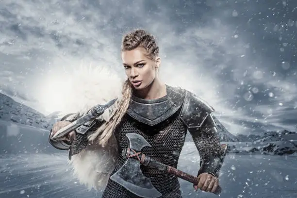 Beautiful blonde weapon wielding female viking warrior queen in Valhalla
