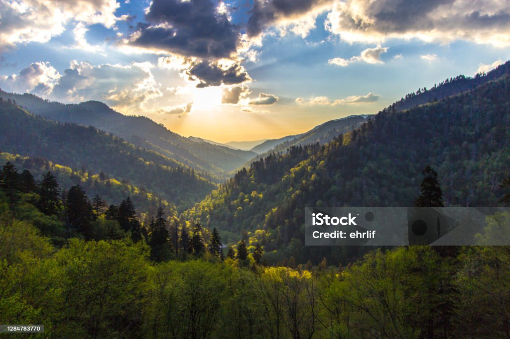 Great Smoky Mountains Sunset At Morton Overlook View from the Newfound Gap overlook over the vast wilderness of the Great Smoky Mountains National Park on the border of North Carolina and Tennessee. Mountain Stock Photo