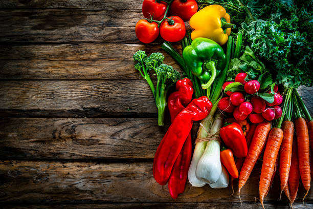 istock Fresh organic vegetables shot from above on rustic wooden table. Copy space 1284783794