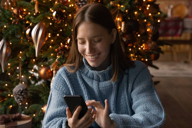 istock Happy woman texting greeting on modern cellphone 1284784167