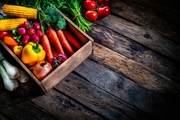 istock Healthy food backgrounds: fresh multicolored vegetables on rustic table. Copy space 1284784386