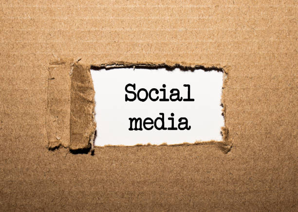 istock The text SOCIAL MEDIA. behind torn brown paper 1284784387