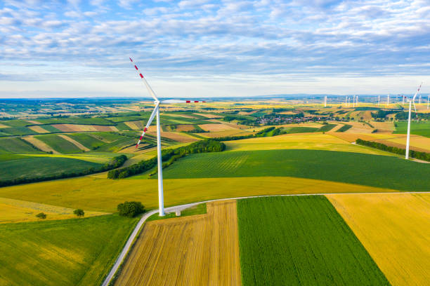 istock Wind power plant with agricultural fields at sunrise 1284784508