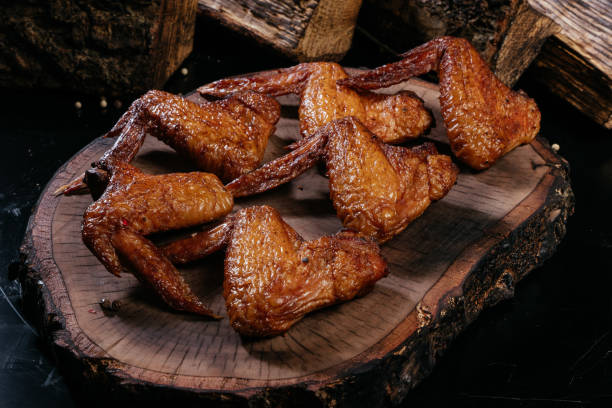 istock Richly smoked chicken wings. wooden background 1284784577