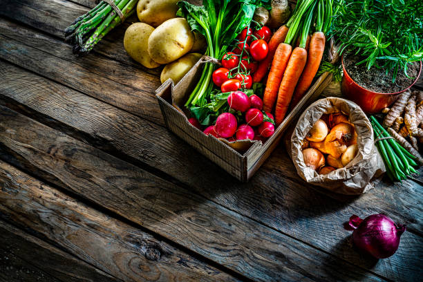 istock Healthy food backgrounds: fresh multicolored vegetables on rustic table. Copy space 1284784579