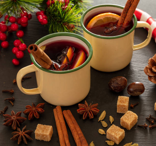 istock Mulled wine, Christmas hot drink in mugs on black stone, closeup view 1284786704