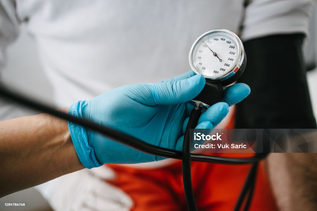 Measuring blood pressure Measuring blood pressure. Pressure gauge. Hypertension and high heart rate Blood Pressure Gauge Stock Photo