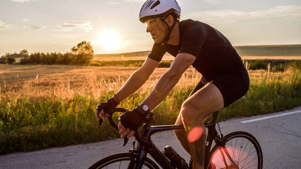 istock Cyclist driving fast through the countryside at sunset 1284788132