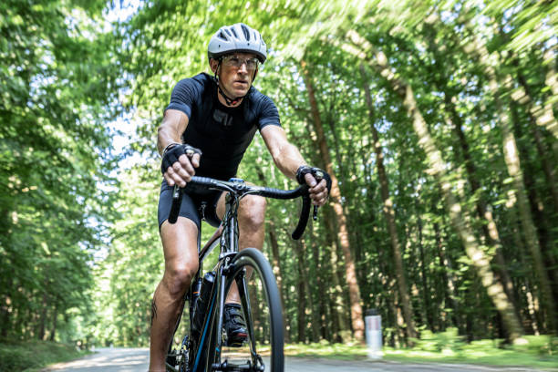 istock Man riding bicycle through the forest on a sunny day 1284788156