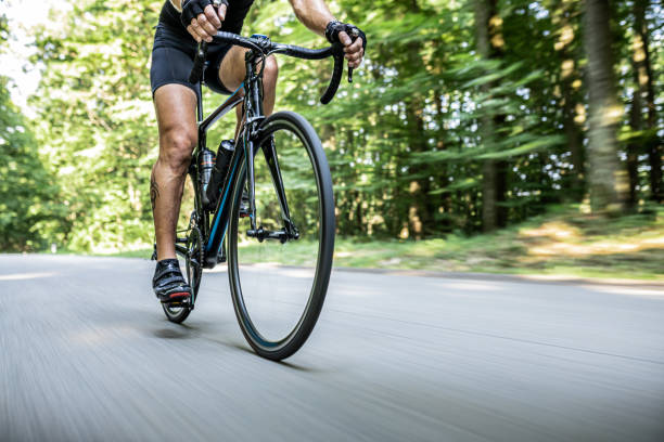 istock Man riding a professional bicycle through the forest 1284788213