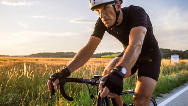 istock Man riding bicycle in countryside 1284788238